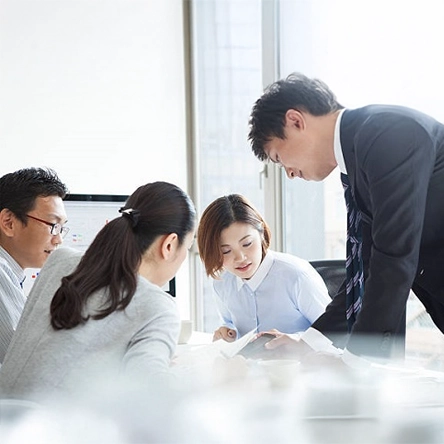 Group of working adults discussing.